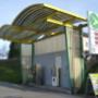 AGROLA Tankstelle in Uznach mit geschwungener Überdachung. Rechts ein Stellschild darüber AGROLA Logo und digitale Preisanzeige. Eine Tanksäule und ein Zahlterminal