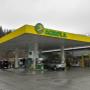 AGROLA Tankstelle in Thusis mit TopShop. Grosse Überdachung. Autos am Tanken. Regnerische Aufnahme. Grosser Vorplatz.